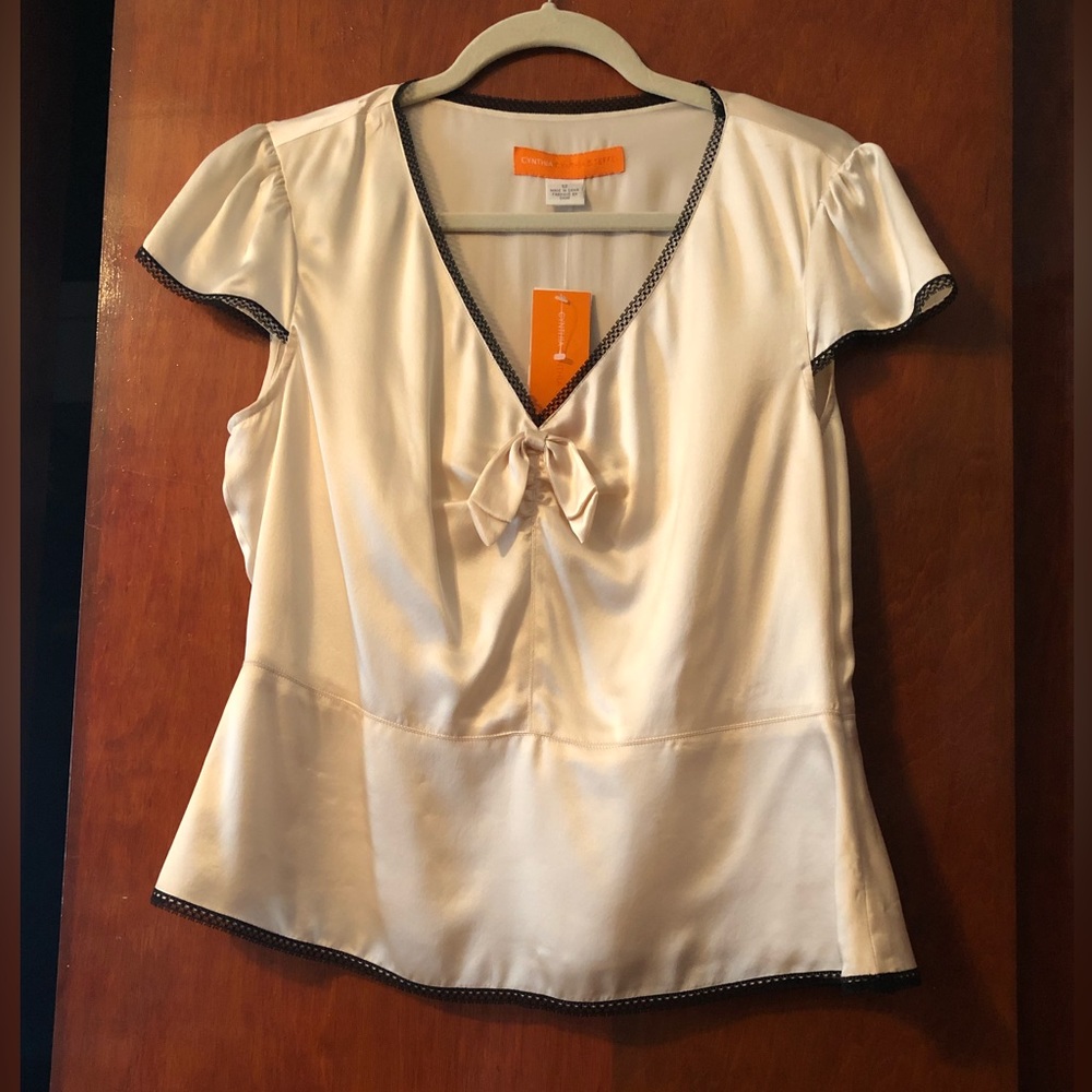 NWT Cynthia Steffe ivory with black trim blouse. Lined with side zipper.$45.00